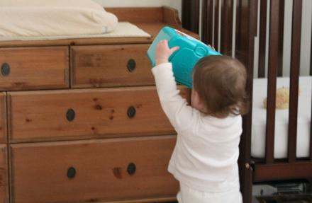 Audrey's first chore.  After changing her diaper, she has to put her wipes back on the dresser.  She's pretty good at it.