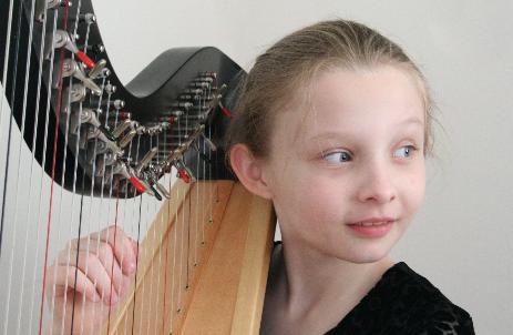 The oldest one with her harp.  I love the light on her face and in her eyes.