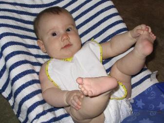 Audrey getting ready to eat her first solid food.  Notice how she's discovered her feet now.
