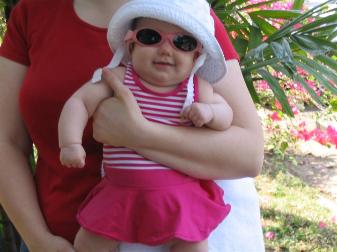 Audrey all decked out to swim, including hat, sunglasses, and her swimsuit.  A lot of gear for fifteen minutes in the pool.