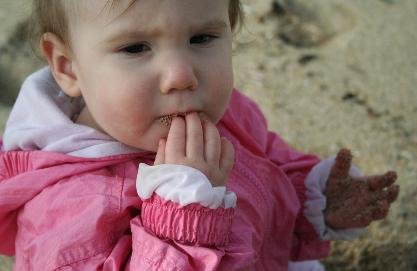 Trying sand for the first time.  She didn't love it.  I'm happy she didn't love it.