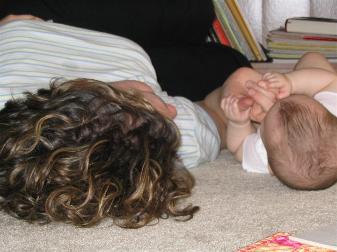 Laura lying on the floor with Audrey.