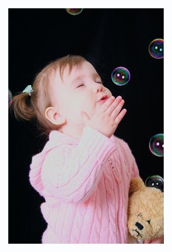 Laura actually took this one.  I blew the bubbles.  If you notice, the bubbles have two reflections of the single light.  One on the near side of the bubble and the other on the far side.