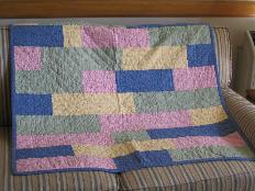 This is the quilt I made for Audrey.  Notice how much bigger the individual pieces are than Laura's quilt.  Looks just about right for me, I'd say.
