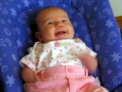 Audrey smiling in her bouncy seat.  Of course, she was moving during this picture, so she kind of looks like psycho baby.  Oh well.