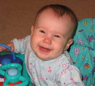 A close up of Audrey in her walker.  You can see her one tooth (that was visible at the time, although both had cut) if you look closely.